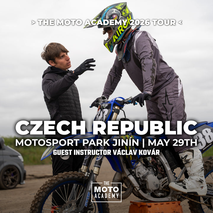 Two individuals with dirt bikes at a motosport event in the Czech Republic, featuring The Moto Academy branding.