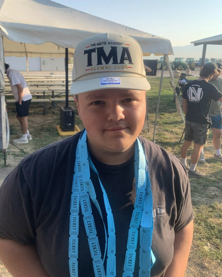 Rider wearing The Moto Academy Alumni Club hat at camp