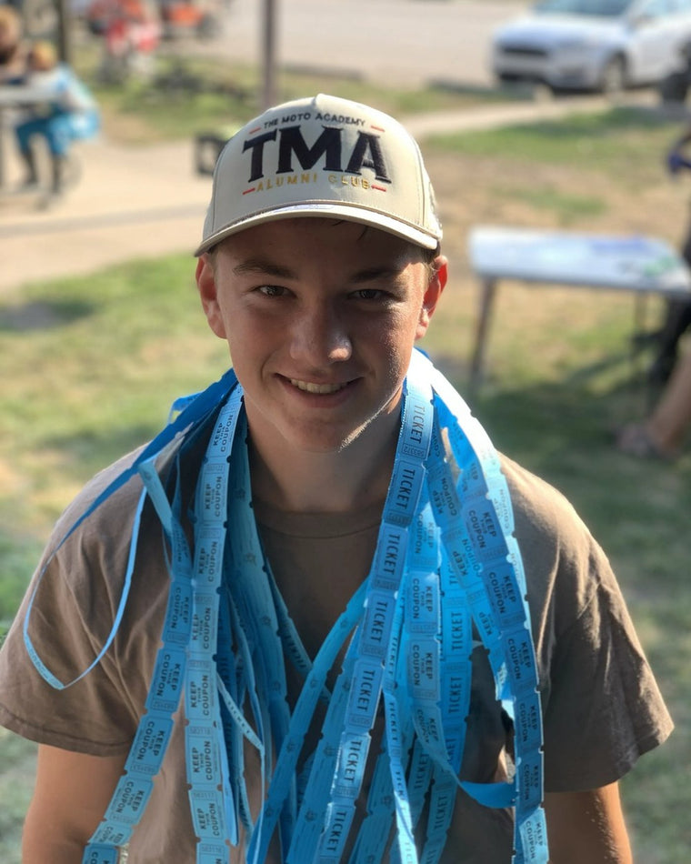 Rider wearing The Moto Academy Alumni Club hat at camp
